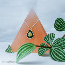 Load image into Gallery viewer, A brilliant orange and green teardrop opal is accented by a wide shadowbox and a delicately detailed border.  Solid sterling silver, some recycled content  Ethiopian Opal cabochon  Pendant 13mm x 21mm  17” long Sterling Silver chain with 2" extender