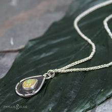 Load image into Gallery viewer, A brilliant orange and green teardrop opal is accented by a wide shadowbox and a delicately detailed border.  Solid sterling silver, some recycled content  Ethiopian Opal cabochon  Pendant 13mm x 21mm  17” long Sterling Silver chain with 2" extender