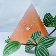 Load image into Gallery viewer, Evie brings the perfect tiny highlight to your look. The lovely Ethiopian Opal shows flashes of peach, green, and yellow and is nestled in a delicate diamond-cut sterling silver chain for extra sparkle. Solid sterling silver, partially recycled  Ethiopian Opal   Pendant 10mm X 6mm  16” long Sterling Silver chain  Lobster claw clasp