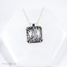 Load image into Gallery viewer, A glamorous Dendritic Quartz held by 8 tapered prongs is capped with a flush set Black Spinel and slides on a sleek silver wheat chain  Details  Solid sterling silver, partially recycled  Dendritic Quartz, Black Spinel  Pendant: 17mm x 22mm  16" Sterling chain, adjustable to 18"  Lobster claw clasp