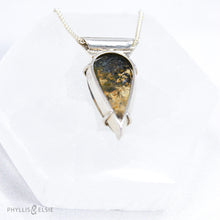 Load image into Gallery viewer, Reminiscent of Art Deco designs, this stunning Dendritic Quartz is held in a 6-prong claw setting crowned with a glowing spark of Golden Topaz.   Details:  Solid sterling silver, partially recycled  Dendritic Quartz with Golden Topaz  Pendant 19mm x 36mm  16” long Sterling Silver wheat chain plus 2” Extender  Lobster claw clasp