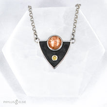 Load image into Gallery viewer, A shimmering Sunstone rises through the thick silver frame of its shadowbox. A faceted golden Topaz adds even more color and sparkle to this striking pendant.  Details  Solid sterling silver, partially recycled  Sunstone & Golden Topaz  Pendant: 28mm x 23mm  18” long Sterling Silver chain plus 2" extension  Lobster-claw clasp