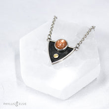 Load image into Gallery viewer, A shimmering Sunstone rises through the thick silver frame of its shadowbox. A faceted golden Topaz adds even more color and sparkle to this striking pendant.  Details  Solid sterling silver, partially recycled  Sunstone & Golden Topaz  Pendant: 28mm x 23mm  18” long Sterling Silver chain plus 2" extension  Lobster-claw clasp