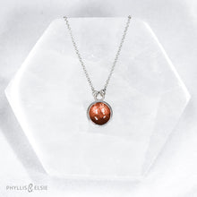 Load image into Gallery viewer, This 10mm Luna necklace features a beautiful rust colored Sunstone set simply in a smooth silver bezel. A slim oval chain completes the clean, classic look you will find yourself wearing over and over.  Details  Solid sterling silver, partially recycled  Sunstone  Pendant: 10mm  16” long Sterling Silver chain   Lobster-claw clasp