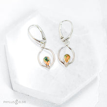 Load image into Gallery viewer, Dainty dangles with set with faceted Ethiopian opals suspended in a sterling frame. The faceted teardrop opals have stunning flashes of orange, yellow, and green depending on the light. Elegant lever-back ear hooks keep your new earrings secure with extra style.  Solid Sterling Silver, partially recycled  Natural Ethiopian Opals  Earring face - 12mm x 18mm  Sterling Lever-back ear hooks
