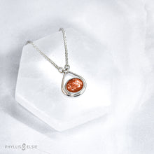Load image into Gallery viewer, A shimmering orange Sunstone set in a silver bezel and nestled in an elegant and minimalist teardrop halo.   Solid sterling silver, partially recycled  Sunstone  Pendant 17mm x 20mm 16” long Sterling Silver chain plus 2" Extension  Lobster claw clasp