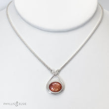 Load image into Gallery viewer, A shimmering orange Sunstone set in a silver bezel and nestled in an elegant and minimalist teardrop halo.   Solid sterling silver, partially recycled  Sunstone  Pendant 17mm x 20mm 16” long Sterling Silver chain plus 2" Extension  Lobster claw clasp