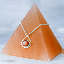 Load image into Gallery viewer, A shimmering orange Sunstone set in a silver bezel and nestled in an elegant and minimalist teardrop halo.   Solid sterling silver, partially recycled  Sunstone  Pendant 17mm x 20mm 16” long Sterling Silver chain plus 2" Extension  Lobster claw clasp