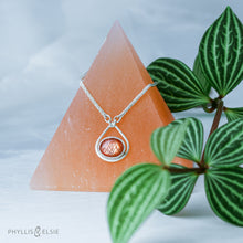 Load image into Gallery viewer, A shimmering orange Sunstone set in a silver bezel and nestled in an elegant and minimalist teardrop halo.   Solid sterling silver, partially recycled  Sunstone  Pendant 17mm x 20mm 16” long Sterling Silver chain plus 2" Extension  Lobster claw clasp