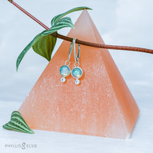 Load image into Gallery viewer, Sweet dewdrops of Ethiopian Opals glow with shades of blue, green, and peach. White Sapphires at an extra touch of sparkle and elegant lever-back ear hooks keep your earrings secure with extra style.  Solid sterling silver, partially recycled  Ethiopian Opal, White Sapphire  Earring face: 8mm x 15mm  Sterling lever-back ear hooks