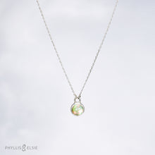 Load image into Gallery viewer, This 8mm Luna necklace features a beautiful Ethiopian Opal set simply in a smooth silver bezel. A a diamond cut chain adds a subtle sparkle to complete the clean, classic look you will find yourself wearing over and over.  Details:  Solid sterling silver, partially recycled  Ethiopian Opal  Pendant: 8mm  16” long Sterling Silver chain   Lobster-claw clasp