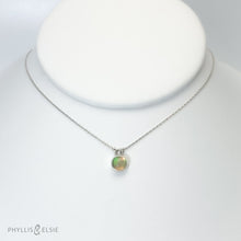 Load image into Gallery viewer, This 8mm Luna necklace features a beautiful Ethiopian Opal set simply in a smooth silver bezel. A a diamond cut chain adds a subtle sparkle to complete the clean, classic look you will find yourself wearing over and over.  Details:  Solid sterling silver, partially recycled  Ethiopian Opal  Pendant: 8mm  16” long Sterling Silver chain   Lobster-claw clasp