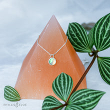 Load image into Gallery viewer, This 8mm Luna necklace features a beautiful Ethiopian Opal set simply in a smooth silver bezel. A a diamond cut chain adds a subtle sparkle to complete the clean, classic look you will find yourself wearing over and over.  Details:  Solid sterling silver, partially recycled  Ethiopian Opal  Pendant: 8mm  16” long Sterling Silver chain   Lobster-claw clasp