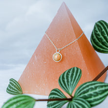 Load image into Gallery viewer, This 9mm Luna necklace features a beautiful orange Ethiopian Opal set simply in a smooth silver bezel. A a diamond cut chain adds a subtle sparkle to complete the clean, classic look you will find yourself wearing over and over.  Details:  Solid sterling silver, partially recycled  Ethiopian Opal  Pendant: 9mm  16” long Sterling Silver chain   Lobster-claw clasp