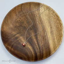 Load image into Gallery viewer, This 10mm Luna necklace features a beautiful rust colored Sunstone set simply in a smooth silver bezel. A slim oval chain completes the clean, classic look you will find yourself wearing over and over.  Details:  Solid sterling silver, partially recycled  Sunstone  Pendant: 10mm  16” long Sterling Silver chain   Lobster-claw clasp