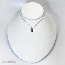 Load image into Gallery viewer, A super flashy Ethiopian Opal wrapped in a silver bezel is framed by a slim patinated shadowbox and hand carved details.   Details:  Solid sterling silver, partially recycled  Ethiopian Opal  Pendant: 10mm x 16mm 16” long Sterling Silver chain plus 2" extension  Lobster-claw clasp