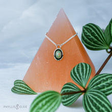 Load image into Gallery viewer, A super flashy Ethiopian Opal wrapped in a silver bezel is framed by a slim patinated shadowbox and hand carved details.   Details:  Solid sterling silver, partially recycled  Ethiopian Opal  Pendant: 10mm x 16mm 16” long Sterling Silver chain plus 2" extension  Lobster-claw clasp