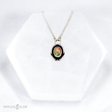 Load image into Gallery viewer, A super flashy Ethiopian Opal wrapped in a silver bezel is framed by a slim patinated shadowbox and hand carved details.   Details:  Solid sterling silver, partially recycled  Ethiopian Opal  Pendant: 10mm x 16mm 16” long Sterling Silver chain plus 2" extension  Lobster-claw clasp