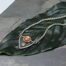 Load image into Gallery viewer, A shimmering Sunstone rises through the thick silver frame of its shadowbox. A faceted golden Topaz adds even more color and sparkle to this striking pendant.  Details  Solid sterling silver, partially recycled  Sunstone & Golden Topaz  Pendant: 28mm x 23mm  18” long Sterling Silver chain plus 2" extension  Lobster-claw clasp
