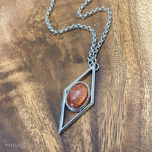 Load image into Gallery viewer, A rich orange oval Sunstone is centered in a diamond frame of polished silver. Beveled edges catch the light and highlight the stone floating in the center.  Details:  Solid sterling silver, partially recycled  Sunstone  Pendant: 17mm x 41mm  18" Sterling chain plus 2" extension   Lobster claw clasp