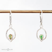 Load image into Gallery viewer, Dainty dangles with set with faceted Ethiopian opals suspended in a sterling frame. The faceted teardrop opals have stunning flashes of orange, yellow, and green depending on the light. Elegant lever-back ear hooks keep your new earrings secure with extra style.  Solid Sterling Silver, partially recycled  Natural Ethiopian Opals  Earring face - 12mm x 18mm  Sterling Lever-back ear hooks