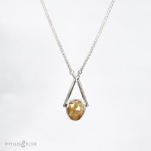 Load image into Gallery viewer, Rosecut Quartz with golden hued crystalline inclusions set in a silver bezel and suspended in an airy frame  Details:  Solid sterling silver, partially recycled  Rutilated Quartz  Pendant: 13mm x 26mm  16” long Sterling Silver chain plus 2” Extender  Lobster-claw clasp
