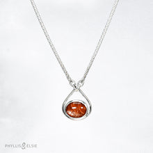 Load image into Gallery viewer, A shimmering orange Sunstone set in a silver bezel and nestled in an elegant and minimalist teardrop halo.   Details  Solid sterling silver, partially recycled  Sunstone  Pendant 17mm x 20mm  16” long Sterling Silver chain plus 2" Extension  Lobster claw clasp