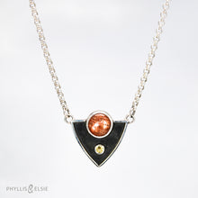 Load image into Gallery viewer, A shimmering Sunstone rises through the thick silver frame of its shadowbox. A faceted golden Topaz adds even more color and sparkle to this striking pendant.  Details  Solid sterling silver, partially recycled  Sunstone & Golden Topaz  Pendant: 28mm x 23mm  18” long Sterling Silver chain plus 2" extension  Lobster-claw clasp
