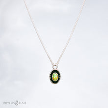 Load image into Gallery viewer, A super flashy Ethiopian Opal wrapped in a silver bezel is framed by a slim patinated shadowbox and hand carved details.   Details  Solid sterling silver, partially recycled  Ethiopian Opal  Pendant: 10mm x 17mm  16” long Sterling Silver chain plus 2" extension  Lobster-claw clasp