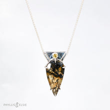 Load image into Gallery viewer, Reminiscent of Art Deco designs, this stunning Dendritic Quartz is held in a 6-prong claw setting crowned with a glowing spark of Golden Topaz.   Details:  Solid sterling silver, partially recycled  Dendritic Quartz with Golden Topaz  Pendant 19mm x 36mm  16” long Sterling Silver wheat chain plus 2” Extender  Lobster claw clasp