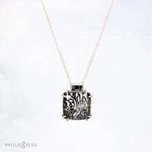 Load image into Gallery viewer, A glamorous Dendritic Quartz held by 8 tapered prongs is capped with a flush set Black Spinel and slides on a sleek silver wheat chain  Details  Solid sterling silver, partially recycled  Dendritic Quartz, Black Spinel  Pendant: 17mm x 22mm  16" Sterling chain, adjustable to 18"  Lobster claw clasp