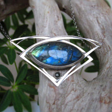 Load image into Gallery viewer, This striking necklace features a stunning deep blue and aqua labradorite marquise cabochon framed by layered silver wings and a demure jade gem. The 16” chain lets the pendant land just below the collarbone. The .925 Sterling silver surround has an oxidized and antiqued finish, giving this piece the look of an heirloom treasure with a story to tell.