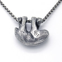 Load image into Gallery viewer, Our charming Three-Toed Sloth hangs happily from a lovely wheat chain, happy to watch the world from a safe perch around your neck! With life-like detail and cuteness to spare, your new silver pal is sure to draw lots of compliments!  We donate a portion of all WildWhere sales to support continuing wildlife conservation efforts!