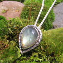 Load image into Gallery viewer, This Stella necklace features a glowing, smooth sage-green Labradorite teardop cabochon that shows glimpses of peach and aqua in bright light. Surrounded with a slightly-offset twisted halo, this pendant stands out despite its small size and soft colors.