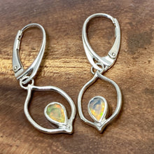 Load image into Gallery viewer, Dainty dangles with set with faceted Ethiopian opals suspended in a sterling frame. The faceted teardrop opals have stunning flashes of orange, yellow, and green depending on the light. Elegant lever-back ear hooks keep your new earrings secure with extra style.  Solid Sterling Silver, partially recycled  Natural Ethiopian Opals  Earring face - 12mm x 18mm  Sterling Lever-back ear hooks