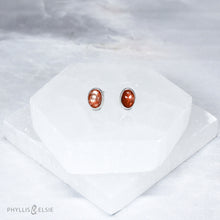 Load image into Gallery viewer, These Sunstone earrings are ﻿simple and sweet but not shy with their beautiful shimmery reddish-orange hue!  Details:  Solid sterling silver, partially recycled  Sunstone  Earring faces: 9mm x 7mm  Surgical Steel butterfly backings
