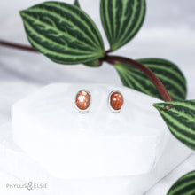 Load image into Gallery viewer, These Sunstone earrings are ﻿simple and sweet but not shy with their beautiful shimmery reddish-orange hue!  Details:  Solid sterling silver, partially recycled  Sunstone  Earring faces: 9mm x 7mm  Surgical Steel butterfly backings
