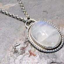 Load image into Gallery viewer, With a beaded halo and glossy Moonstone, the Clara necklace has a traditionally feminine flair and would pair perfectlywith lace. T he lightly antiqued silver has a semi-matte surface in the recesses and polished edges, softening the effect of the metal. 
