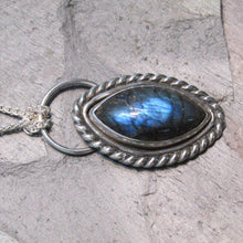 Load image into Gallery viewer, Our Daphne necklaces all feature a stunning deep blue marquise cut Labradorites. This royal hue is one of the most desired shades of the stone and looks stunning set in silver.  This Daphne is wrapped by a silver twist and crowned with a large circular bail through which a shimmery silver chain is looped
