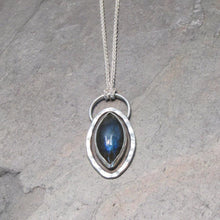 Load image into Gallery viewer, Our Daphne necklaces all feature a stunning deep blue marquise cut Labradorites. This royal hue is one of the most desired shades of the stone and looks stunning set in silver.  This Daphne is surrounded by a hammered silver halo and crowned with a large circular bail through which a shimmery silver chain is looped.
