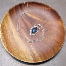 Load image into Gallery viewer, Our Daphne necklaces all feature a stunning deep blue marquise cut Labradorites. This royal hue is one of the most desired shades of the stone and looks stunning set in silver.  This Daphne is surrounded by a hammered silver halo and crowned with a large circular bail through which a shimmery silver chain is looped.
