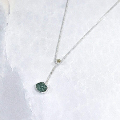 A rich green raw emerald dangles from a tiny glowing labradorite. This y-shaped necklace is perfect for deep necklines and adding the perfect amount of color without overwhelming your look!