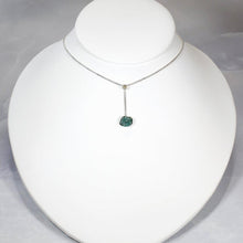 Load image into Gallery viewer, A rich green raw emerald dangles from a tiny glowing labradorite. This y-shaped necklace is perfect for deep necklines and adding the perfect amount of color without overwhelming your look!
