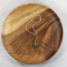 Load image into Gallery viewer, A rich green raw emerald dangles from a tiny glowing labradorite. This y-shaped necklace is perfect for deep necklines and adding the perfect amount of color without overwhelming your look!
