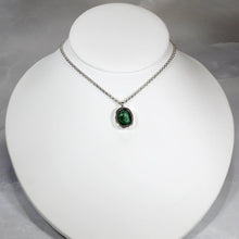Load image into Gallery viewer, A beautiful hand-cut emerald is showcased in a simple banded bezel - geometric but still natural. A thicker rolo chain balances out the small but solid pendant and a two-inch extender gives you flexibility with different necklines. 
