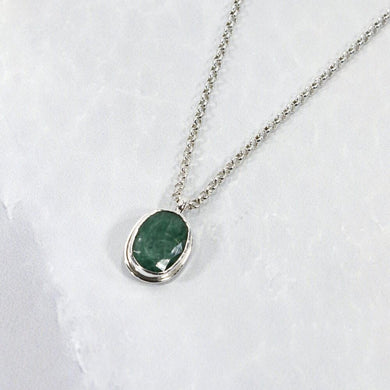 A beautiful hand-cut emerald is showcased in a simple banded bezel - geometric but still natural. A thicker rolo chain balances out the small but solid pendant and a two-inch extender gives you flexibility with different necklines. 