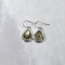 Load image into Gallery viewer, A perfect match for the Stella Classic necklace, these dangly drop earrings of mossy green labradorite are wrapped snugly with a banded bezel and swing freely to catch the light.
