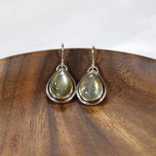 Load image into Gallery viewer, A perfect match for the Stella Classic necklace, these dangly drop earrings of mossy green labradorite are wrapped snugly with a banded bezel and swing freely to catch the light.
