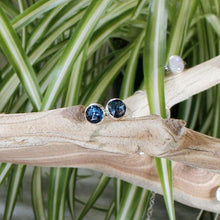 Load image into Gallery viewer, These sweet little earrings feature ethically sourced rosecut Teal Kyanite set in a simple recycled silver bezel. At 9mm wide, they are the perfect size for everyday wear while still adding a flash of sparkle  to your look! These earrings pair perfectly with the Luna Teal Kyanite Necklace.
