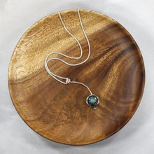 Load image into Gallery viewer, With its exceptional deep blue Labradorite, Taylor carries a mystical hint of midnight. Dangling from a wheat chain and accented by a thin silver band and tiny silver pebble, this necklace is delicate but eye-catching.
